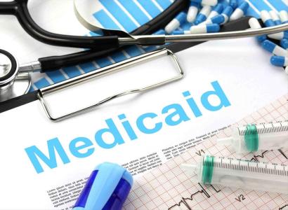Syringes and pills and word Medicaid