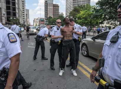 Black man being handcuffed by cops