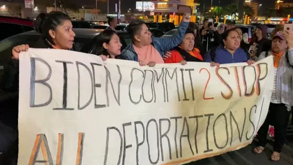 Immigrants holding a banner