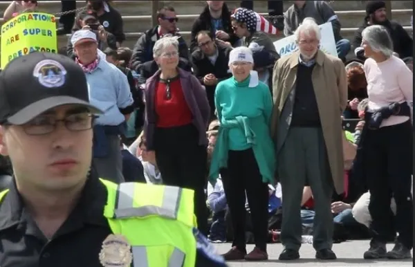 Demonstration with four people in handcuffs