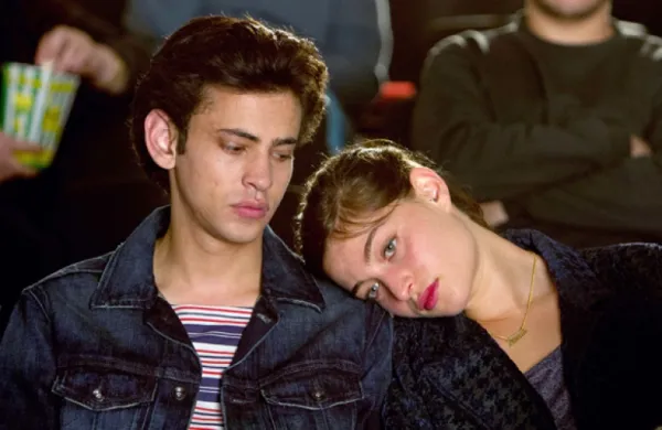 Girl with head on young man's shoulder