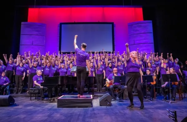 Chorus and conductor with raised fists