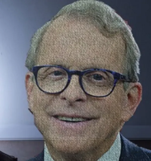 Smiling older white man wearing round black-rimmed glasses