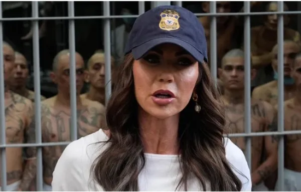 Woman in baseball cap in front of El Salvador prison