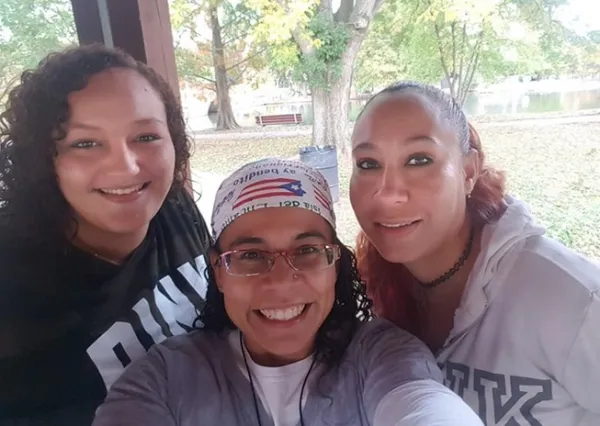 Three women including Esther in the middle