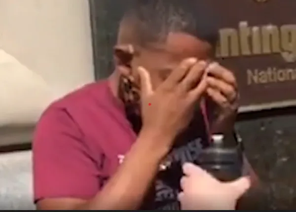 Black man with his head in his hands