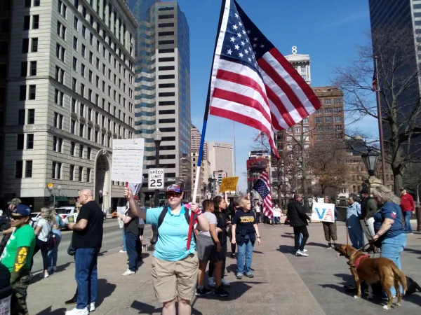 Protesters and one holding US flag