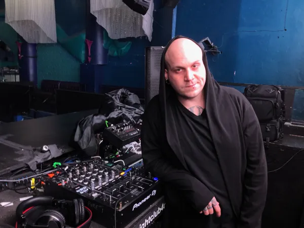 Man standing next to mixing board