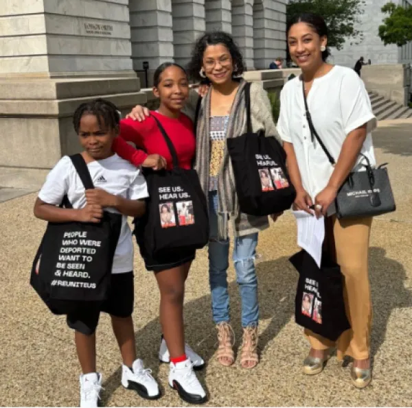 A mother and three kids posing