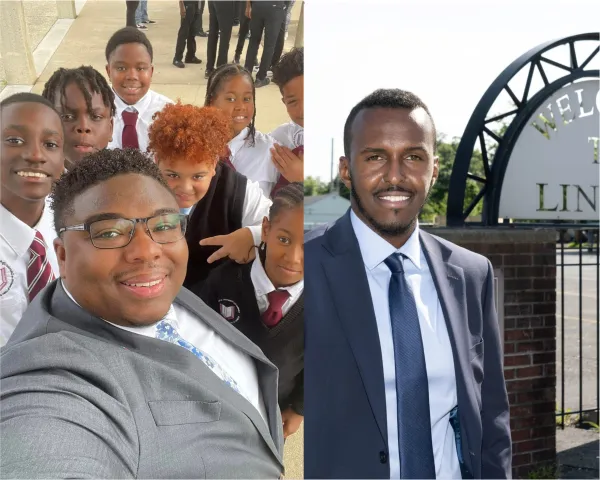 Two black men in suits smiling