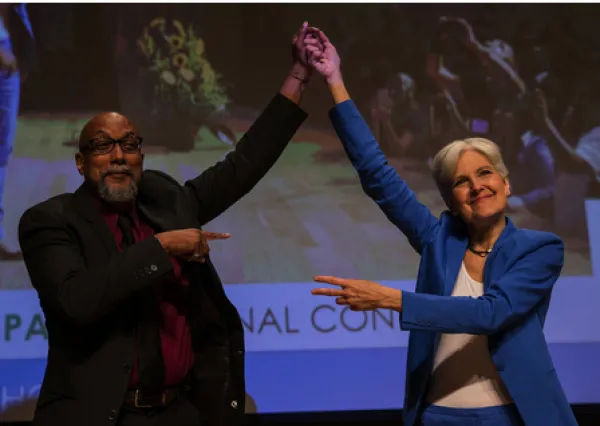 Ajamu and Jill holding up their hands in victory