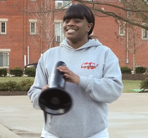 Young black woman with bullhorn outside at rally