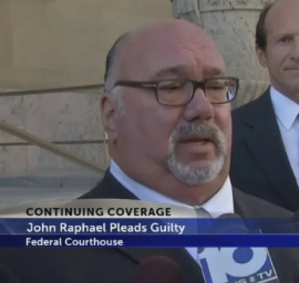 Older man with glasses and a gray goatee