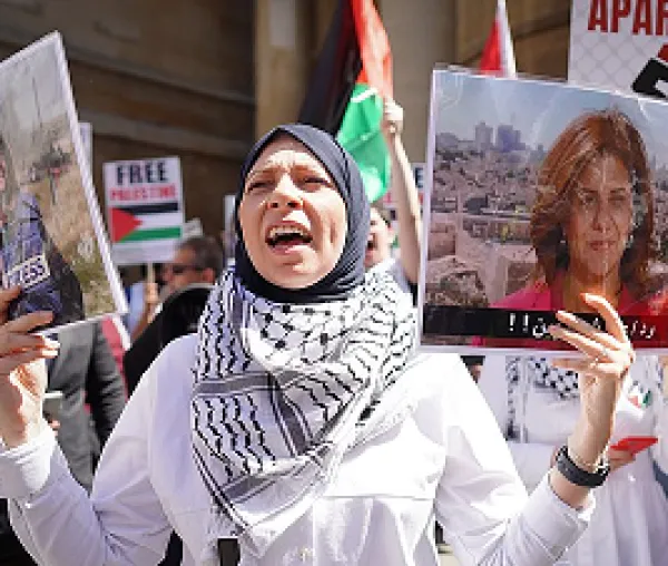 Woman protesting and holding photo of Shireen
