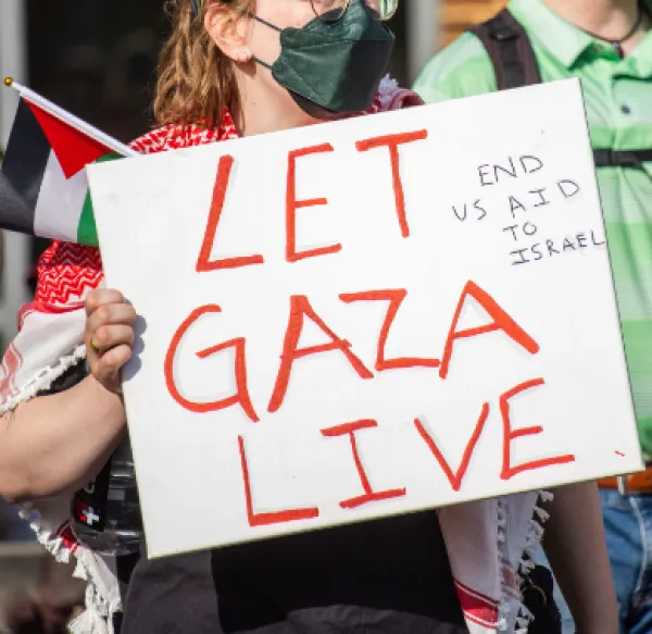 Student holding sign saying Let Gaza Live