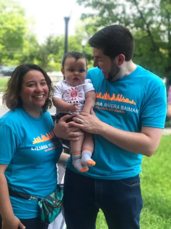 A young couple and the man holding a baby