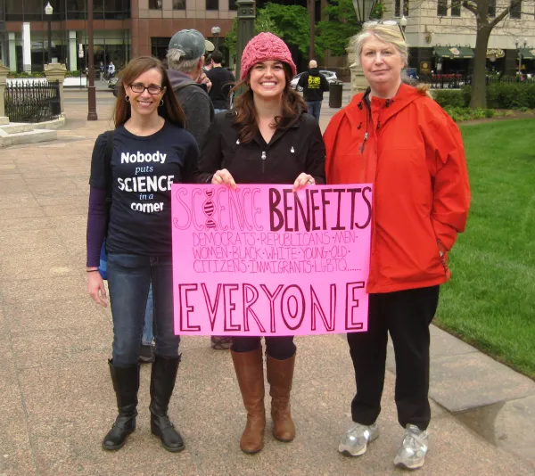 Three women holding sign that says Science Benefits Everyone