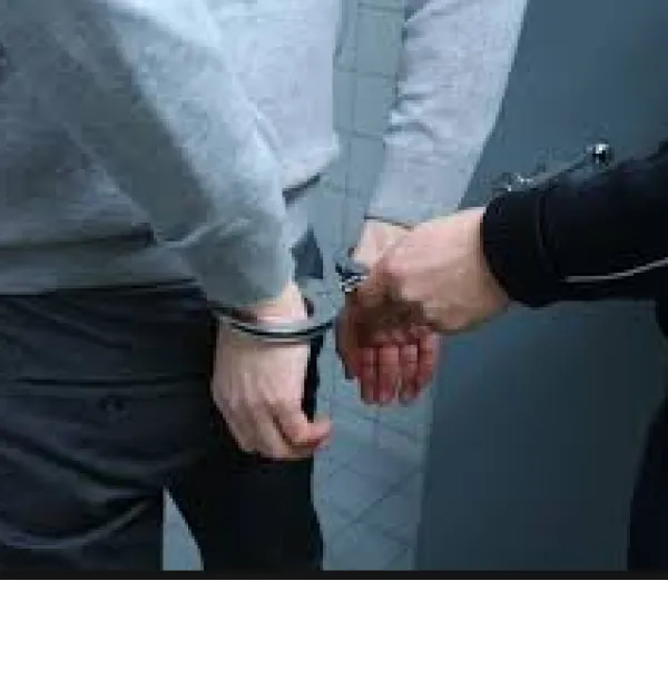 Back of white man with white cop hand putting handcuffs on him