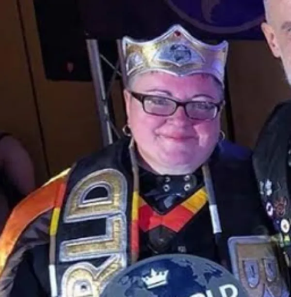 Smiling woman in a crown and sash