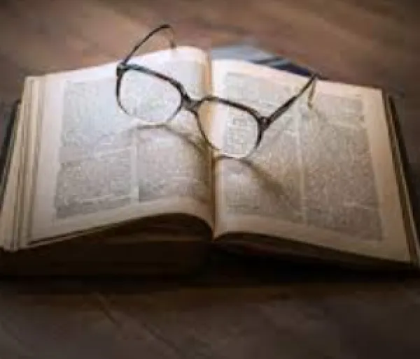 Open book with glasses lying on it