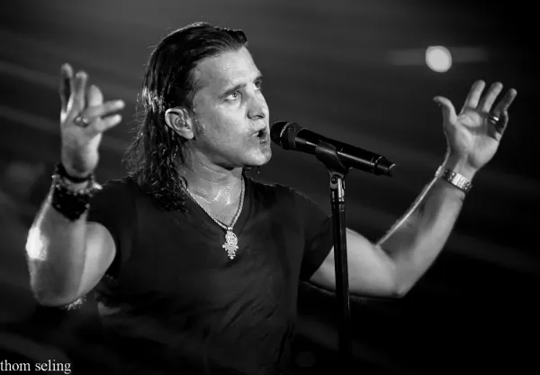 Scott Stapp with arms up singing