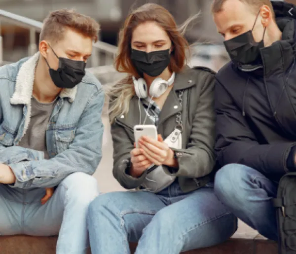 Three young people wearing black face masks