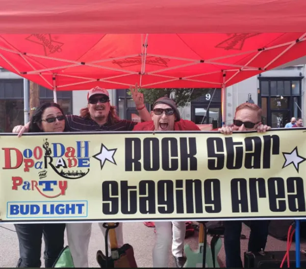 People holding sign saying Rock Star Staging Area