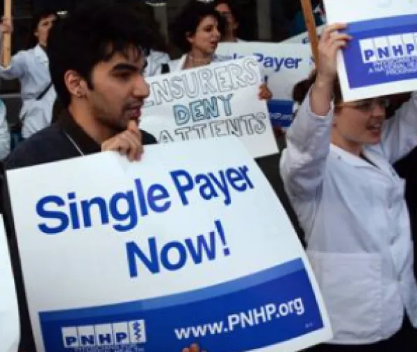 Guy holding Single Payer Now sign