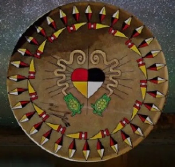 Round mandala with Native American symbols and a heart in the middle between two swiggly  lines depicting the serpent mound