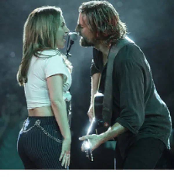 Side view of man and woman singing to each other into a mic, man is playing  guitar