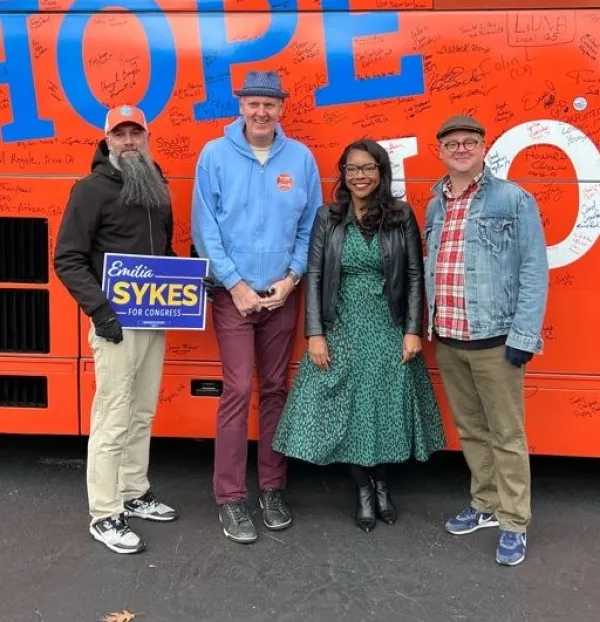 Four people standing and posing