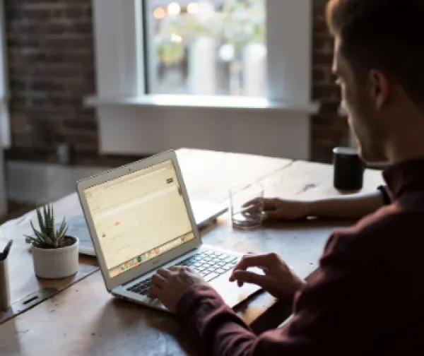 Guy working on a laptop at home
