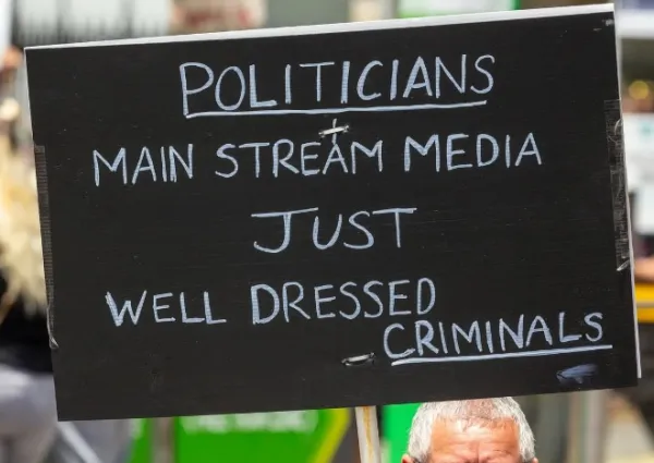 Sign saying Politicians, mainstream media, just well dressed criminals