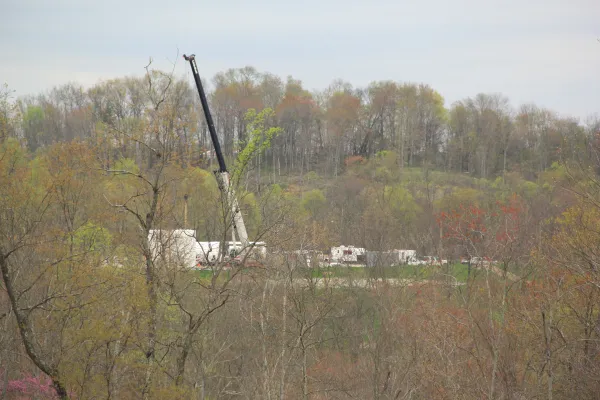 What looks like a crane and extracting equipment within trees in a forest