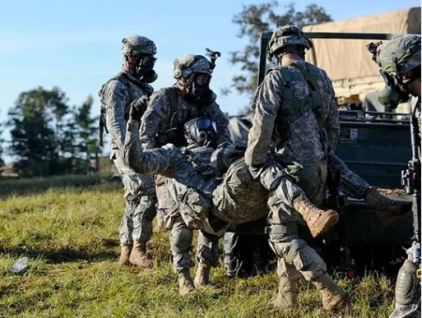 Soldiers carrying wounded man