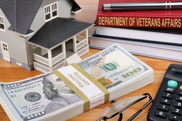 Money, house, book titled Dept of Veterans Affairs