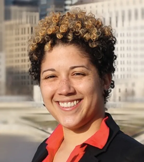 Head shot of young black woman with short curly hair smiling