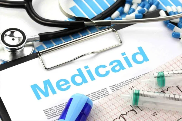 Syringes and pills and word Medicaid