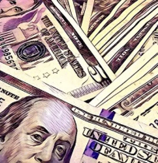 Close up of many dollars scattered on top of each other